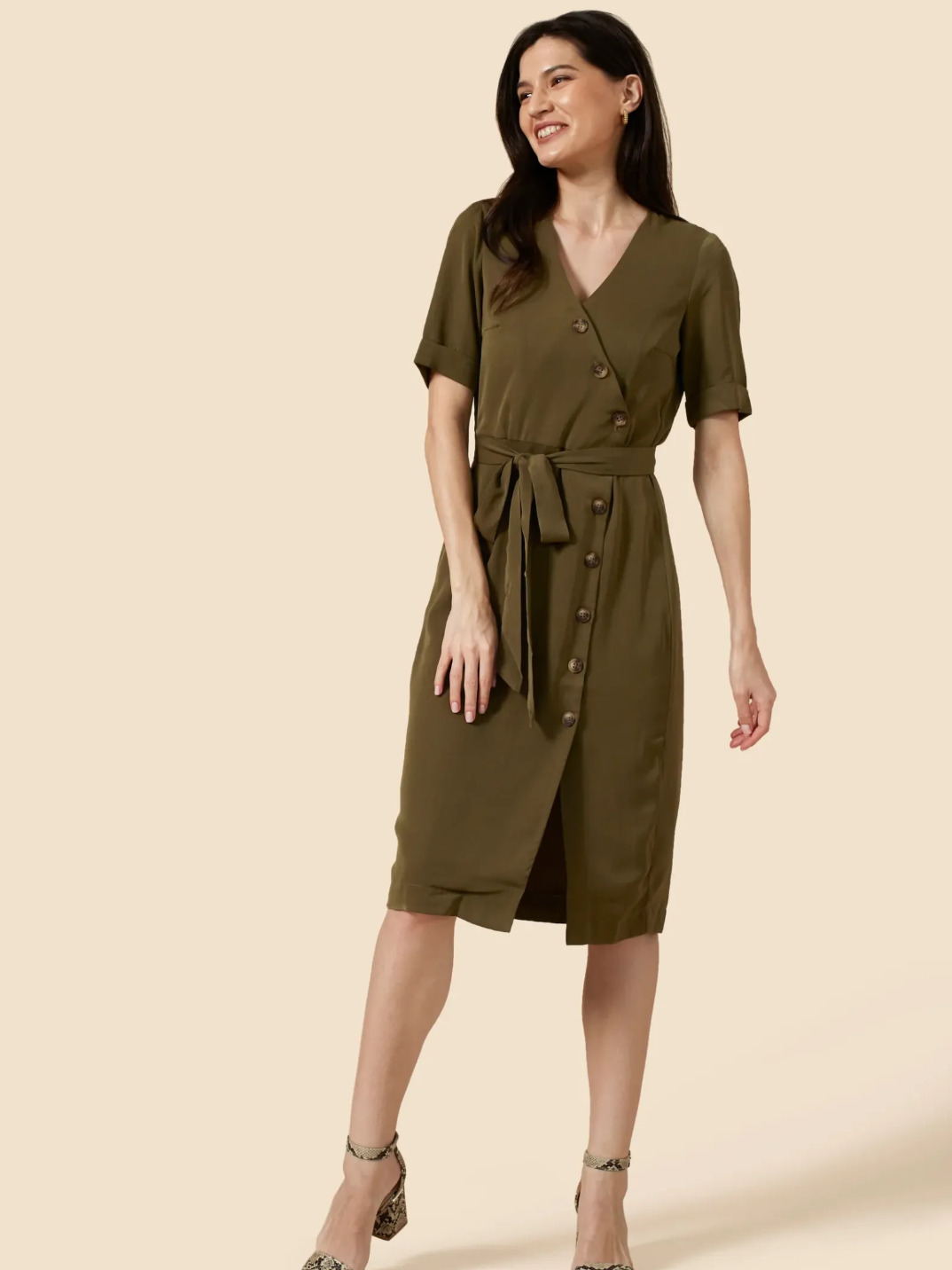 Meet The Emelie: Your new go-to dress (or duster jacket!). With a waist-enhancing tie and asymmetric tortoise shell button detail, The Emelie creates the perfect silhouette. Adjust the height of the front slit to style for work or the weekend. For maximum versatility, undo all the buttons and wear as a light duster jacket. A true capsule wardrobe staple.