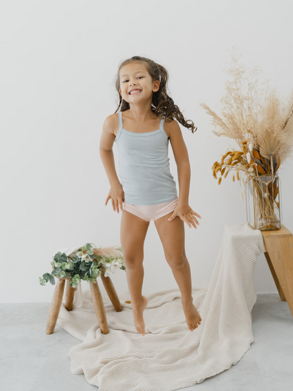 Kids camisoles blue trendy children's fashion sustainable brand eco-friendly Just Peachy Underwear is crafted in TENCEL™ Modal, fibers extracted from naturally grown beech wood by an environmentally responsible integrated pulp-to-fiber process. The FSC and Oeko Tex certified modal is biodegradable, free from harmful chemicals and interwoven using Micro technology for a finer quality of lightness and the softest touch.