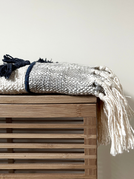 With neutral colors and soft tassels, this throw blanket brings a versatile yet an inviting ambience to any living space.
