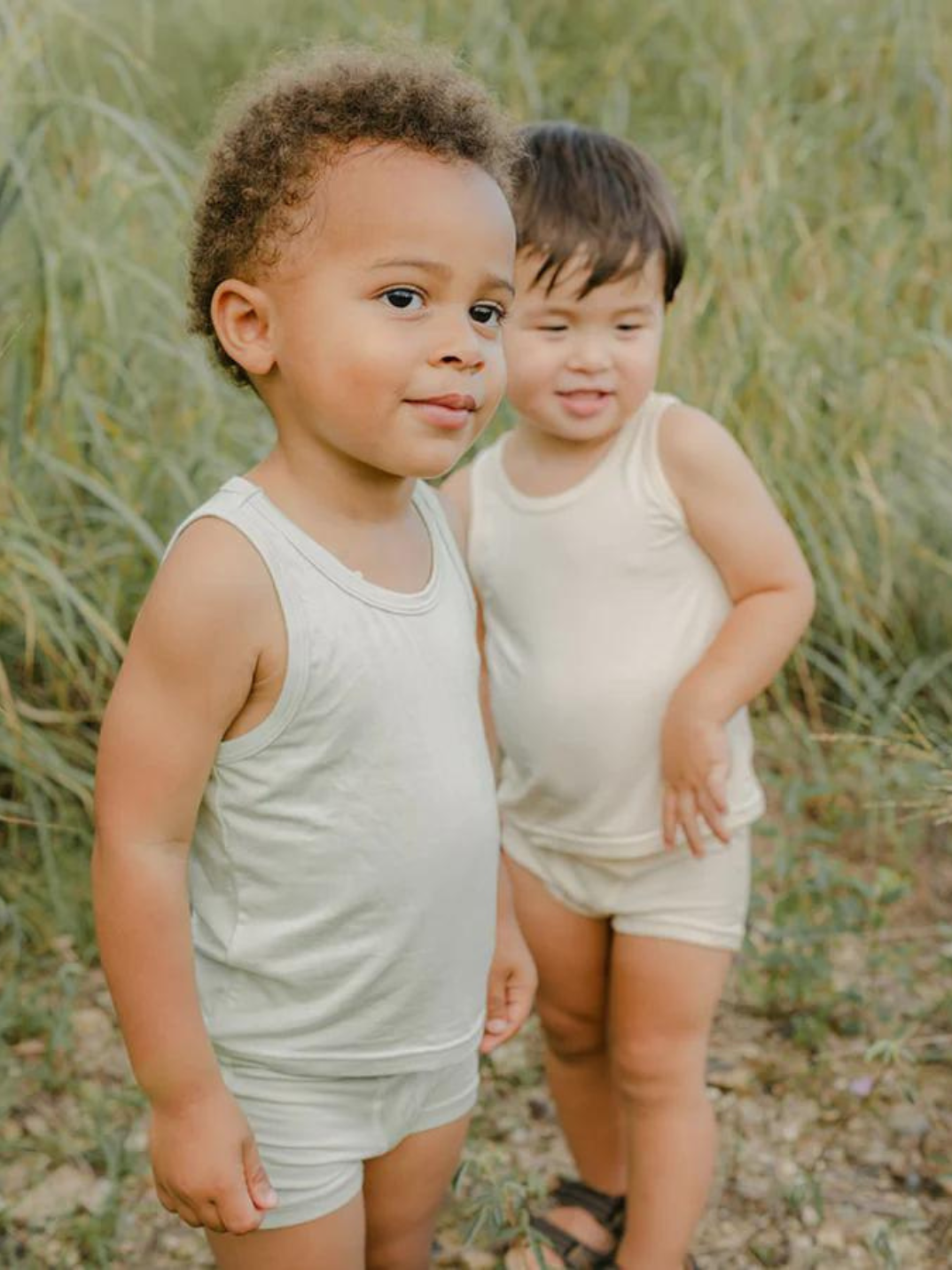 These tank tops are super soft and gentle on your little ones' skin. Designed with a loose, unisex fit for play, movement and a comfy night's rest. Wear the breathable layer under garments for day or snooze in the ultimate comfort. Made with eco modal fabric. This set comes with 1x green tank top and 1x cream tank top.