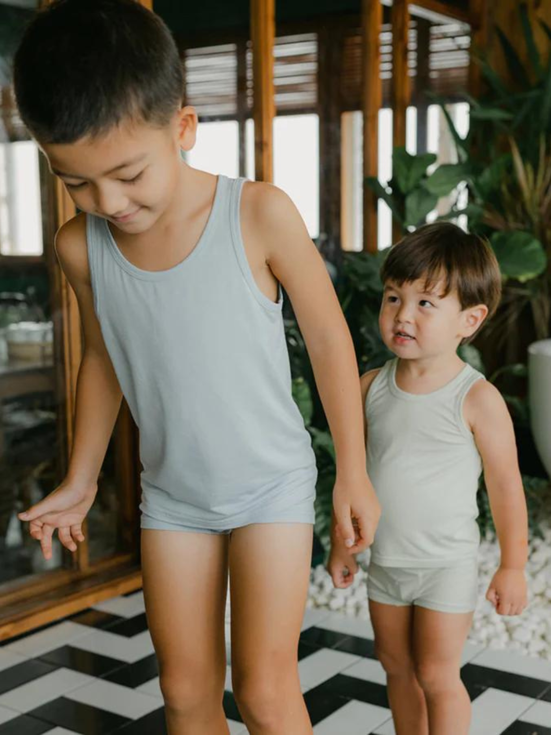 These tank tops are super soft and gentle on your little ones' skin. Designed with a loose, unisex fit for play, movement and a comfy night's rest. Wear the breathable layer under garments for day or snooze in the ultimate comfort. Made with eco modal fabric. This set comes with: 1x green tank top and 1x blue tank top.