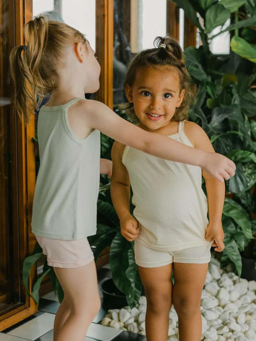 Just Peachy Camisoles are super soft and gentle on your little ones' skin. Designed with a snug fit for play, movement and a comfy night's rest. Add the breathable Camisole layer under your day clothes or snooze in maximum comfort. Made with Lenzing® TENCEL™ Micro Modal Fibers interwoven with Eco Soft Technology exclusively for Just Peachy. Green and cream kids super comfortable kids camis. Sustainable eco-friendly brand.