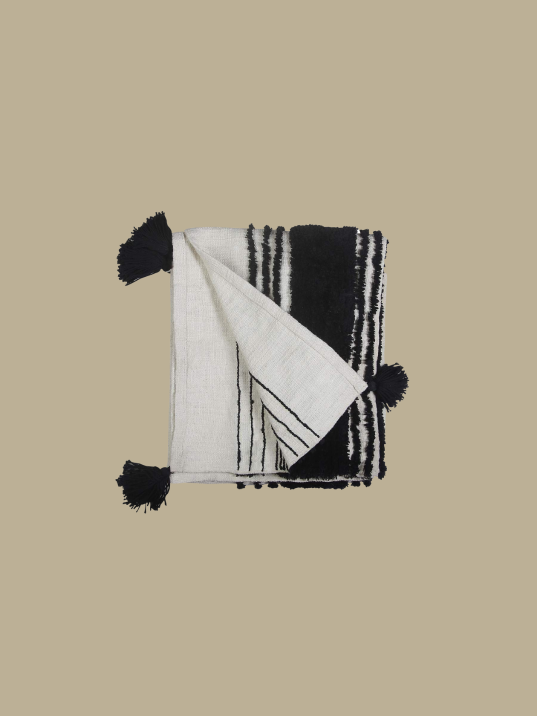This simple soft white slub cotton throw is elevated with bold luxurious tufted black stripes and thick tassels on each corner, giving you the perfect understated luxury aesthetic.