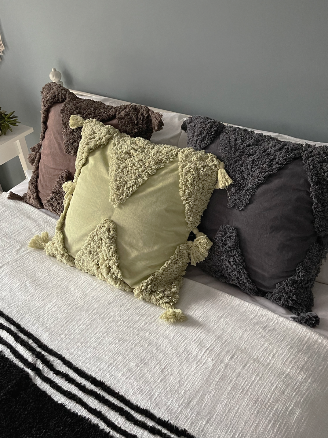 This simple soft white slub cotton throw is elevated with bold luxurious tufted black stripes and thick tassels on each corner, giving you the perfect understated luxury aesthetic.